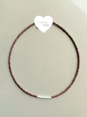 A timeless piece handcrafted with rich maroon beads