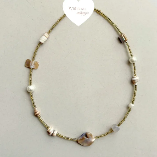 Delicate beach-inspired necklace featuring golden beads