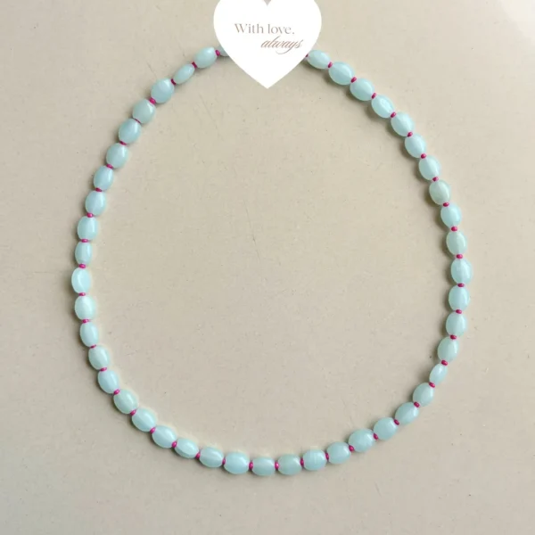 Soft aqua beads paired with tiny pink accents